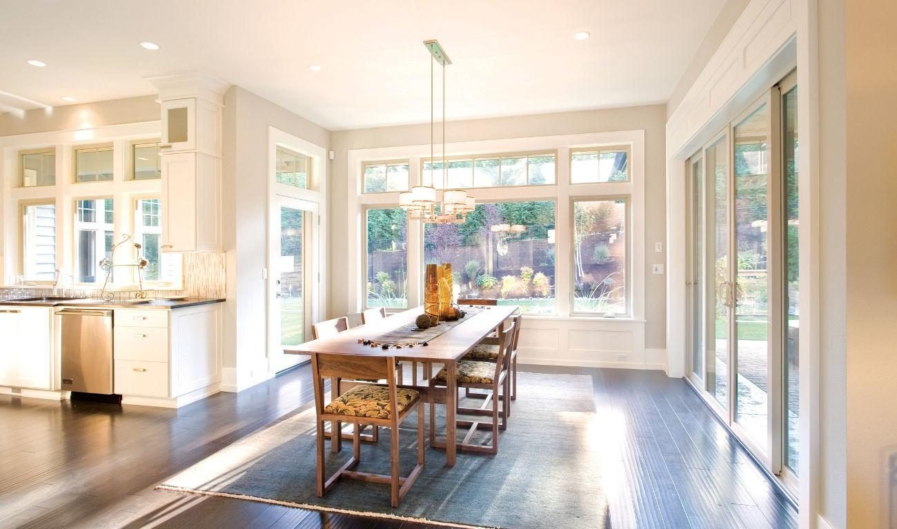 Bright dining room with floor-to-ceiling windows and natural light